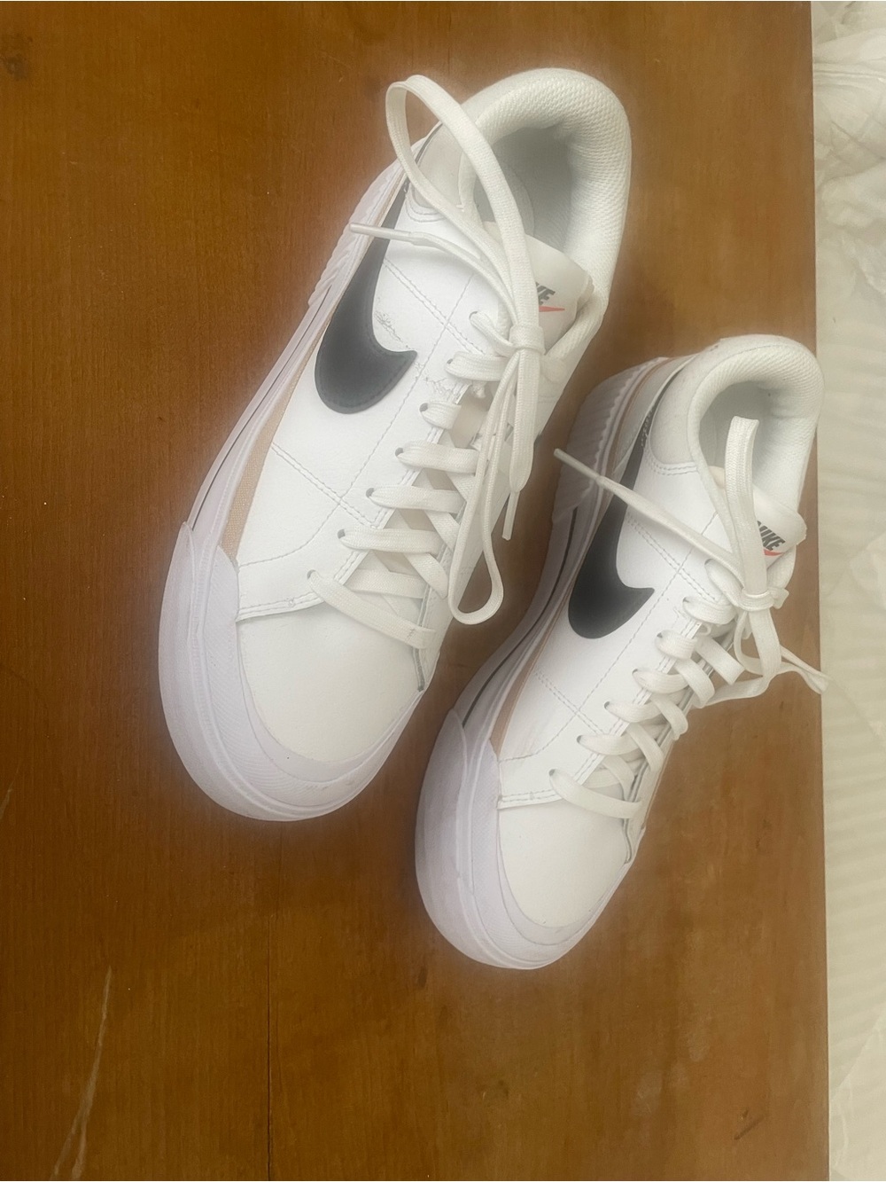 Nike White Low-Top Sneakers with Black Swoosh